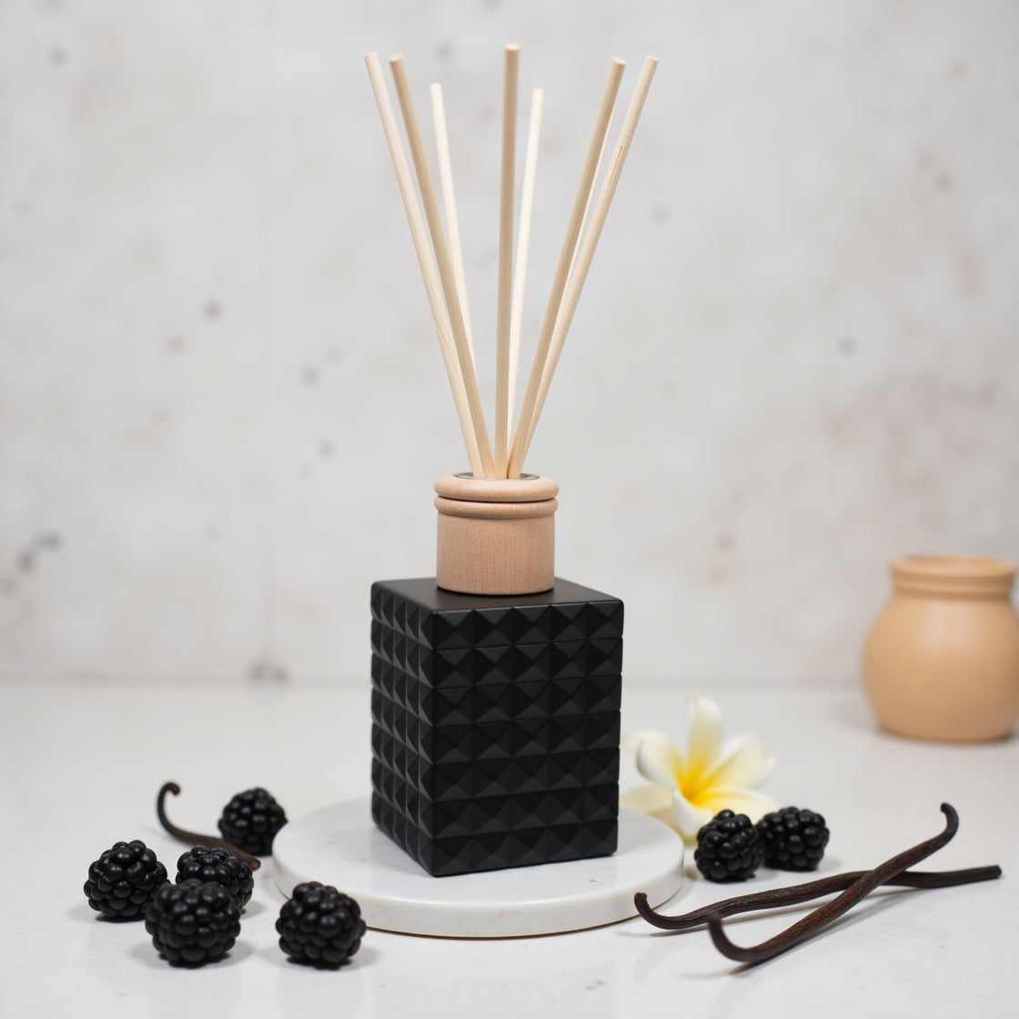 A Black Raspberry & Vanilla scented reed diffuser in a matte black bottle.