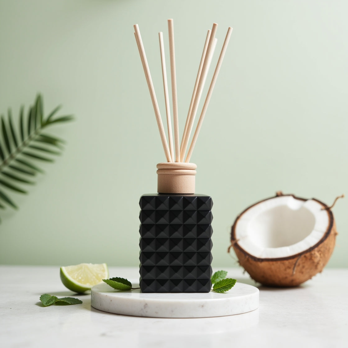 A tropical Coconut Lime Punch scented reed diffuser in a matte black bottle.