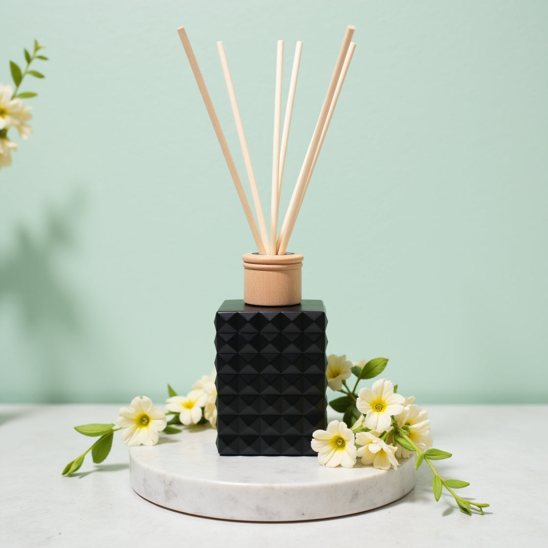 An elegant Japanese Honeysuckle floral reed diffuser in a matte black bottle.