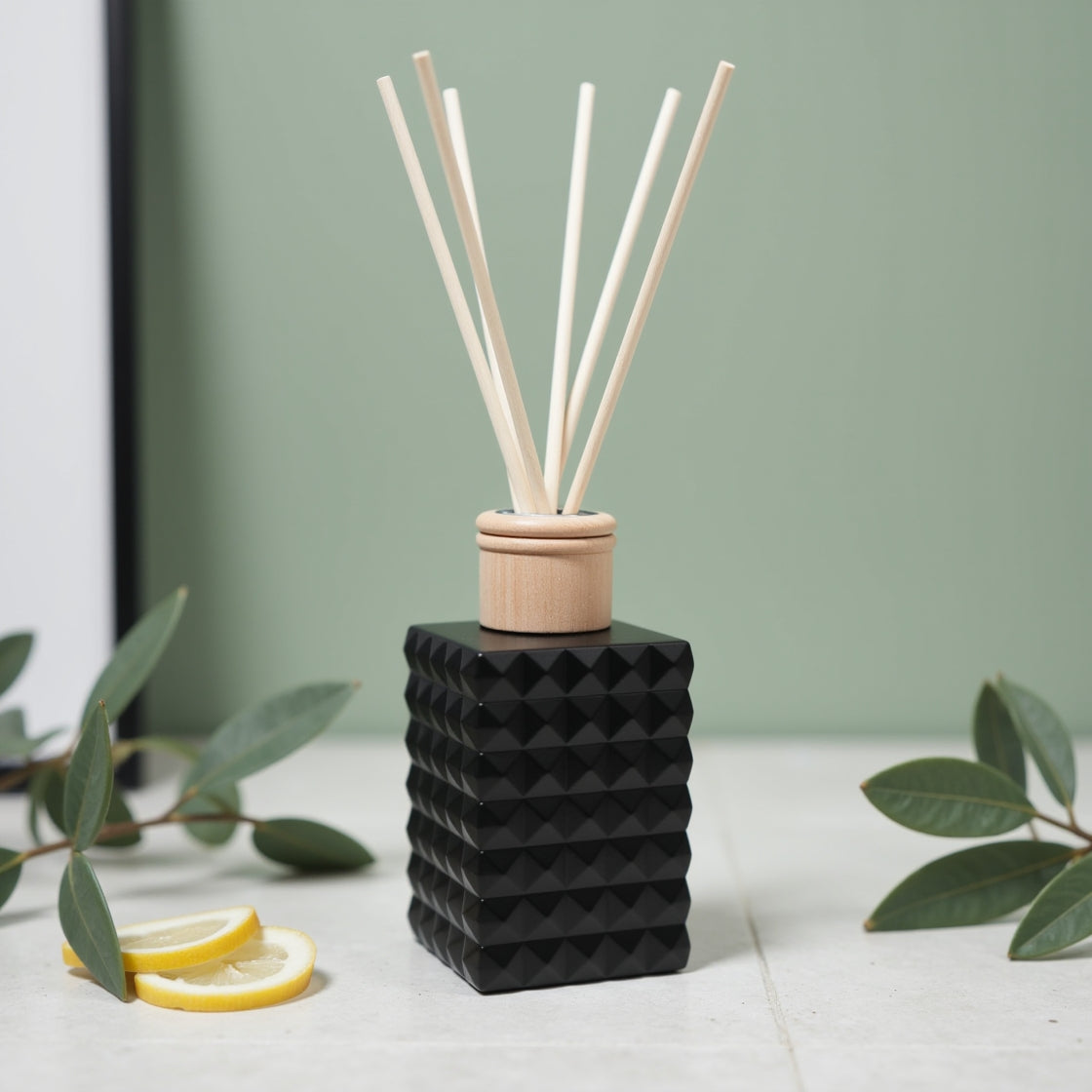 A native Lemon Myrtle scented reed diffuser in a matte black bottle.
