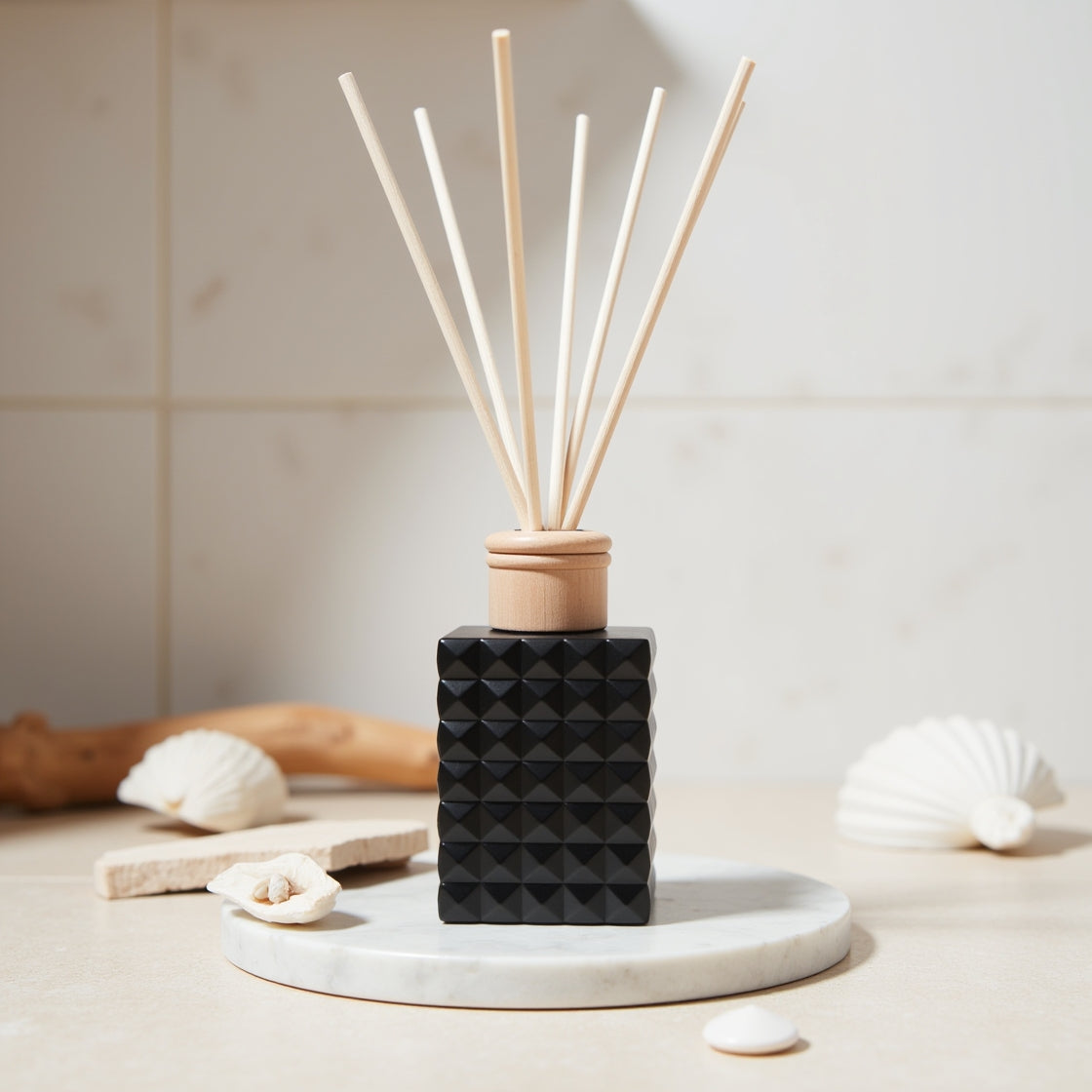 A fresh Life's a Beach scented reed diffuser in a matte black bottle.